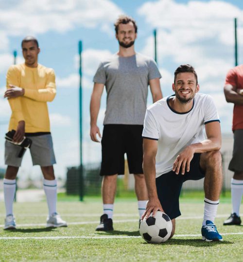 multiethnic-soccer-team-standing-on-soccer-pitch-registration